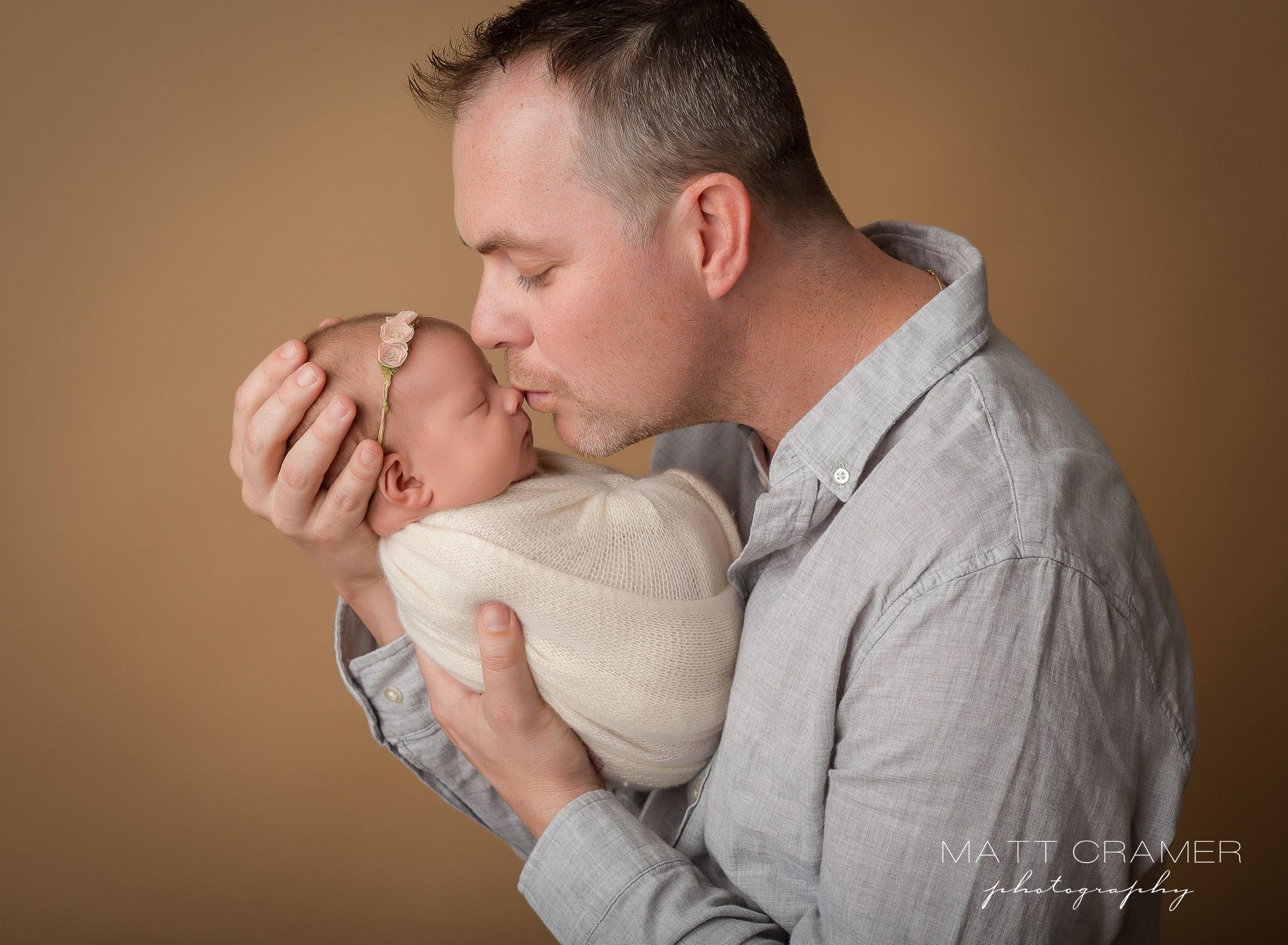 Dad kissing his newborn baby girl