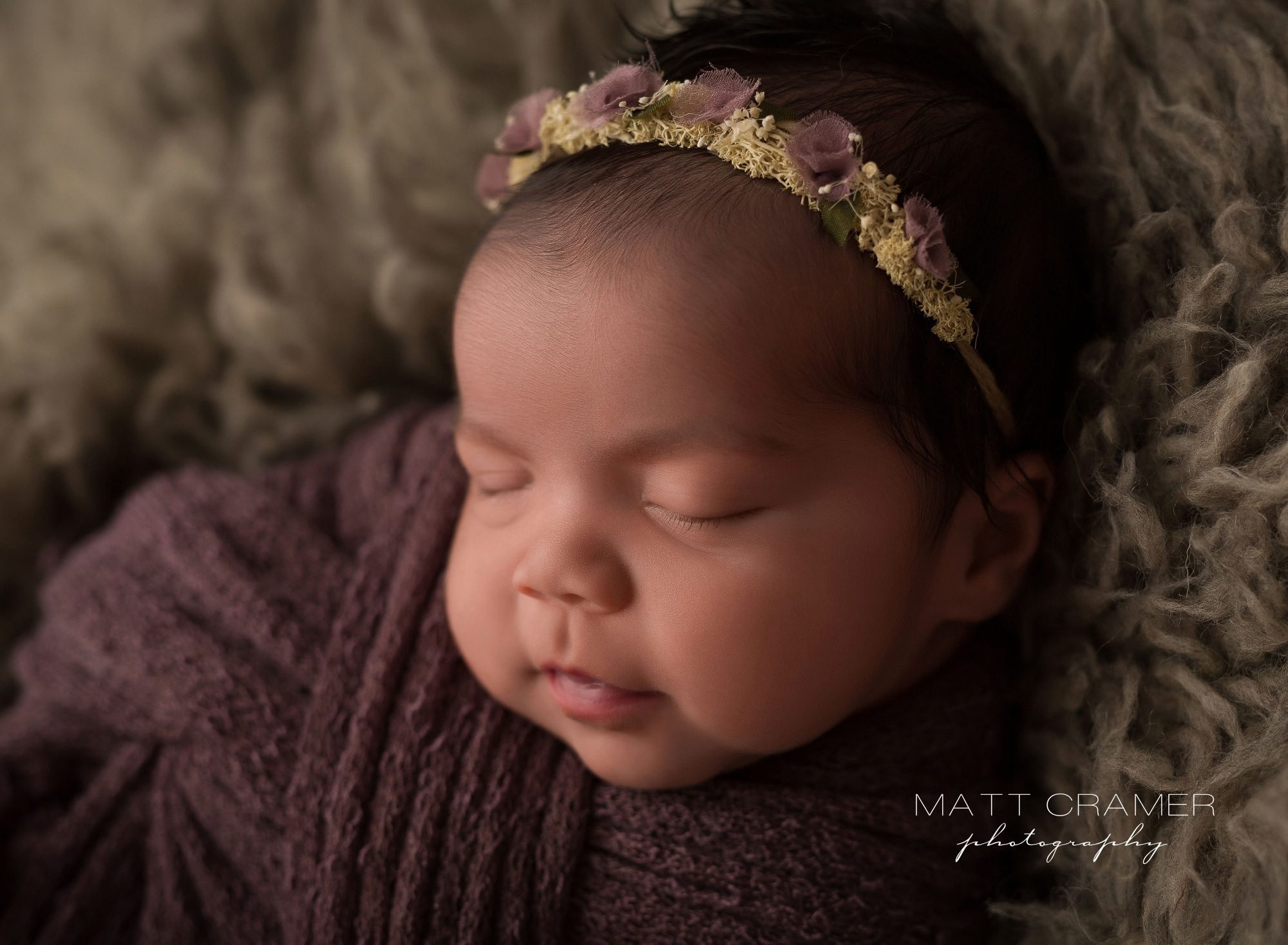 baby girl sleeping in purple swaddle with boho style headband Newborn Photography in Los Angeles