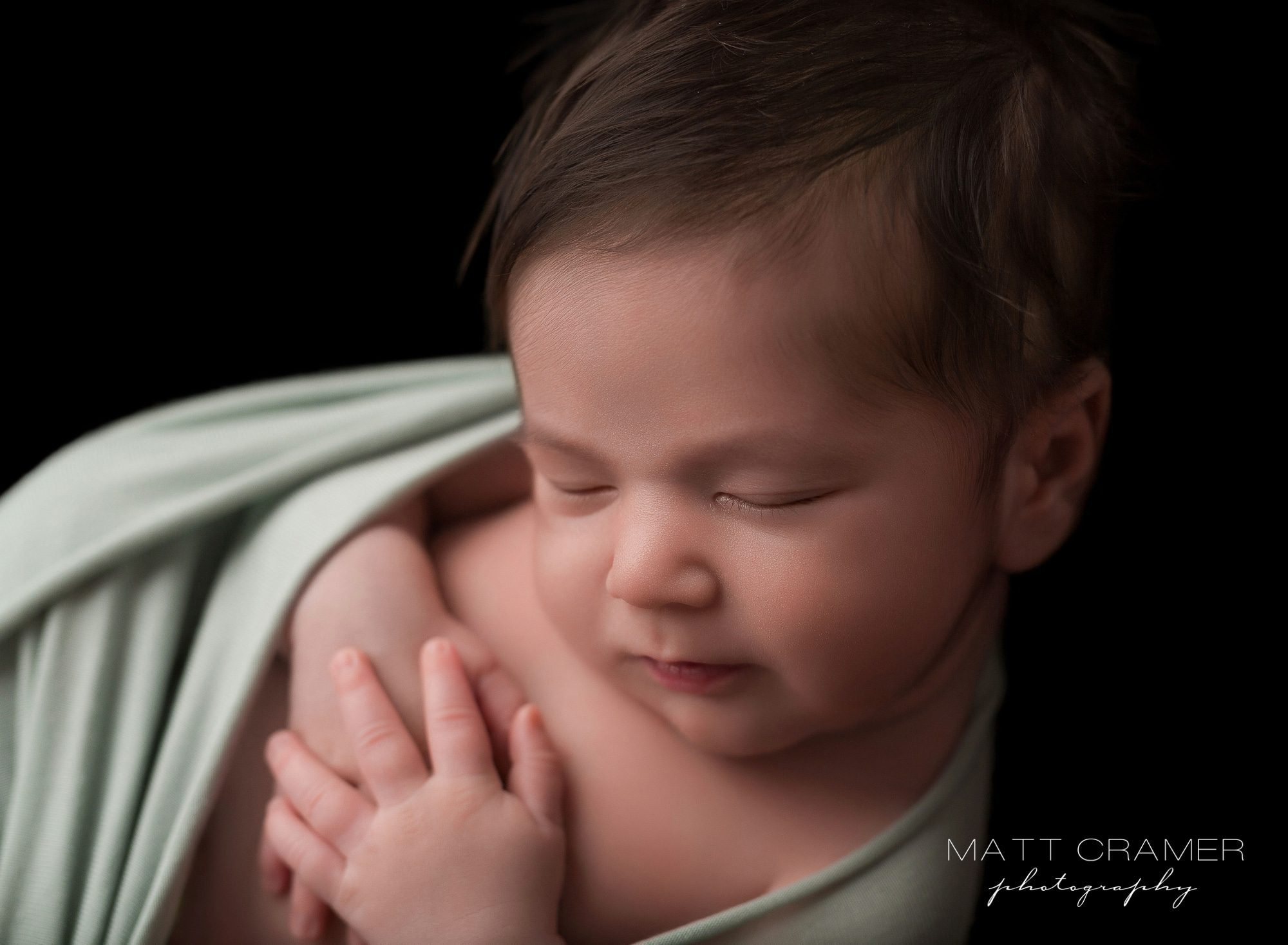 Posing newborn baby on black background