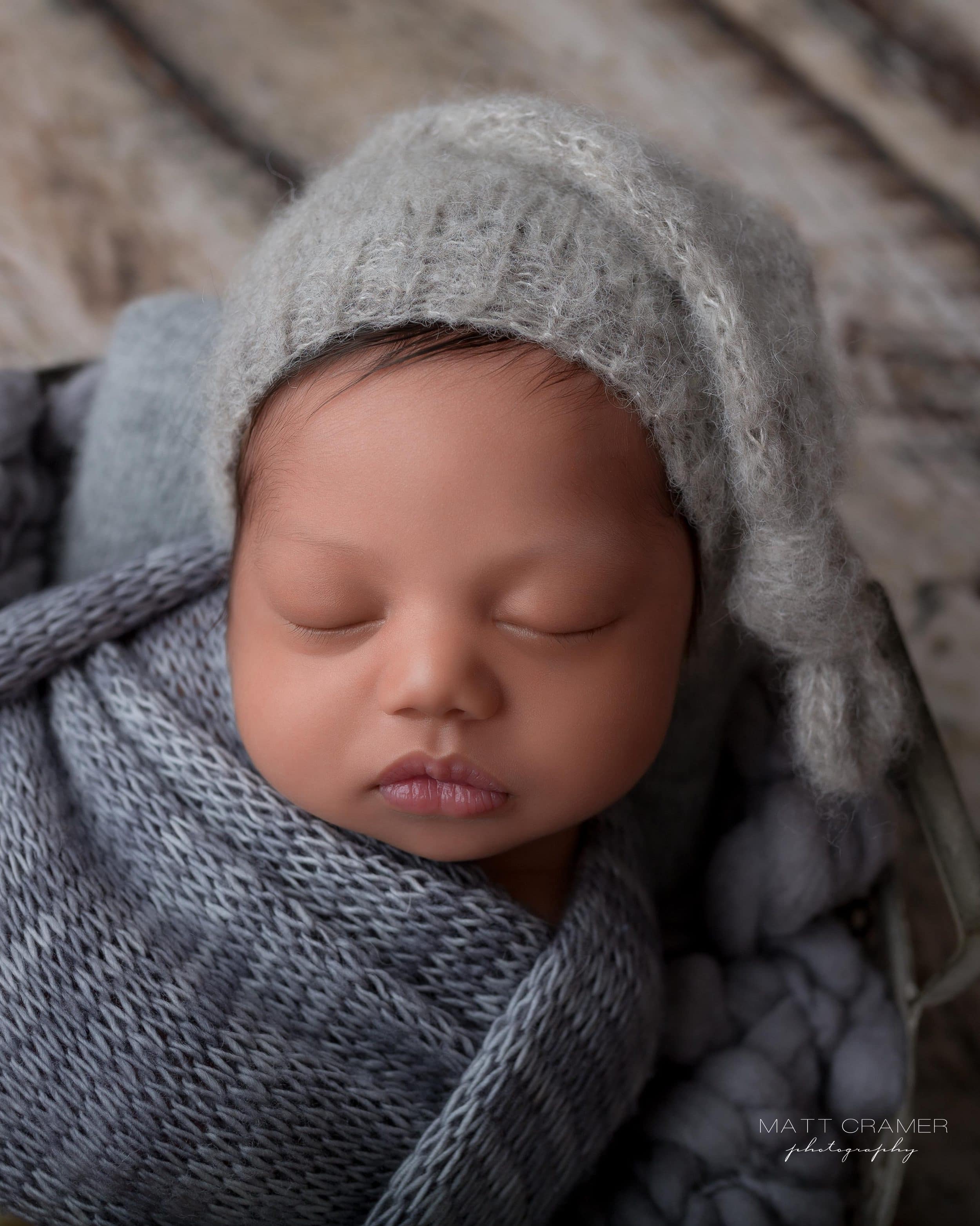 vertical shot of newborn baby wearing knit hat