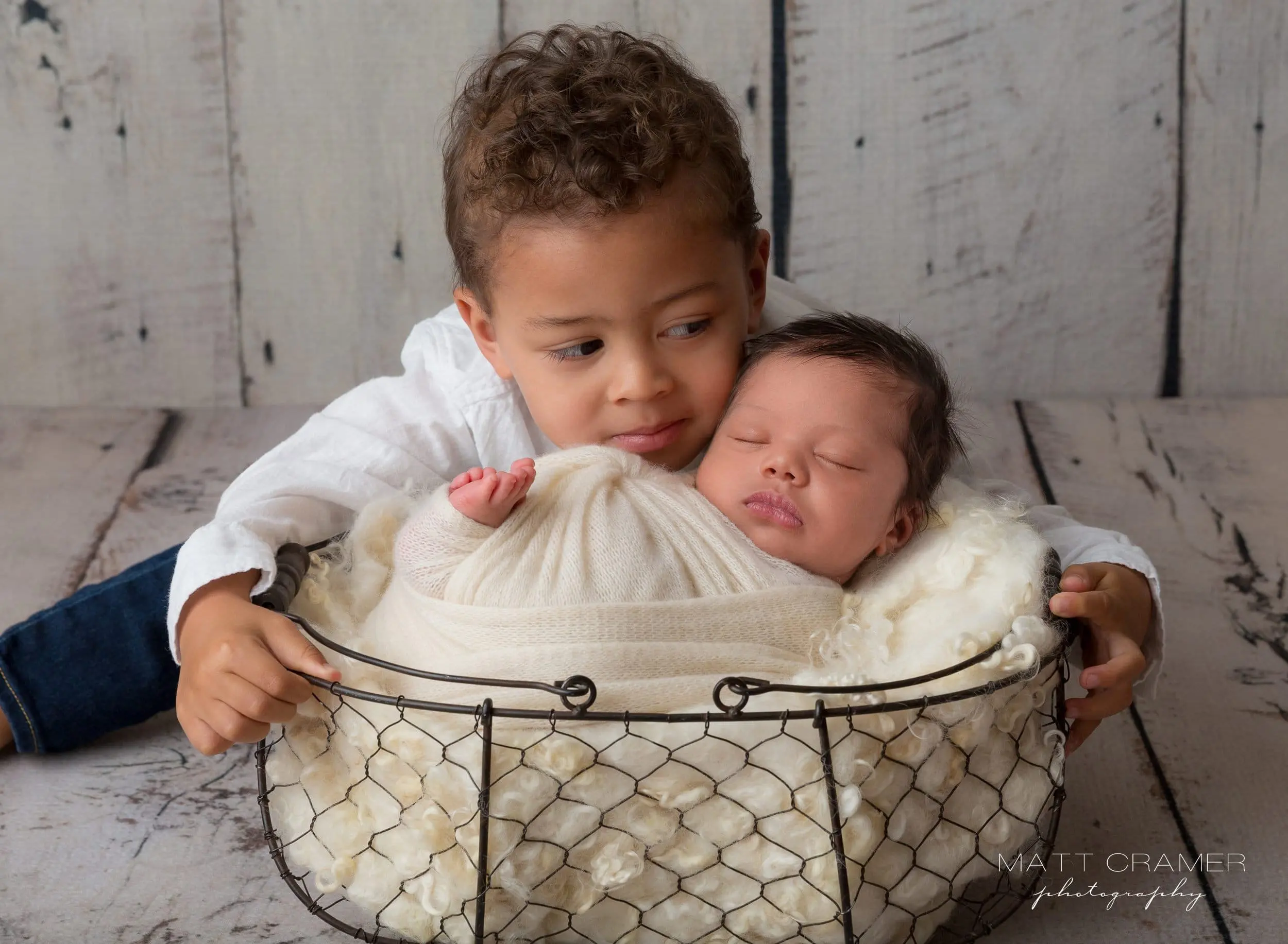 big brother with baby in newborn photo shoot in Los Angeles