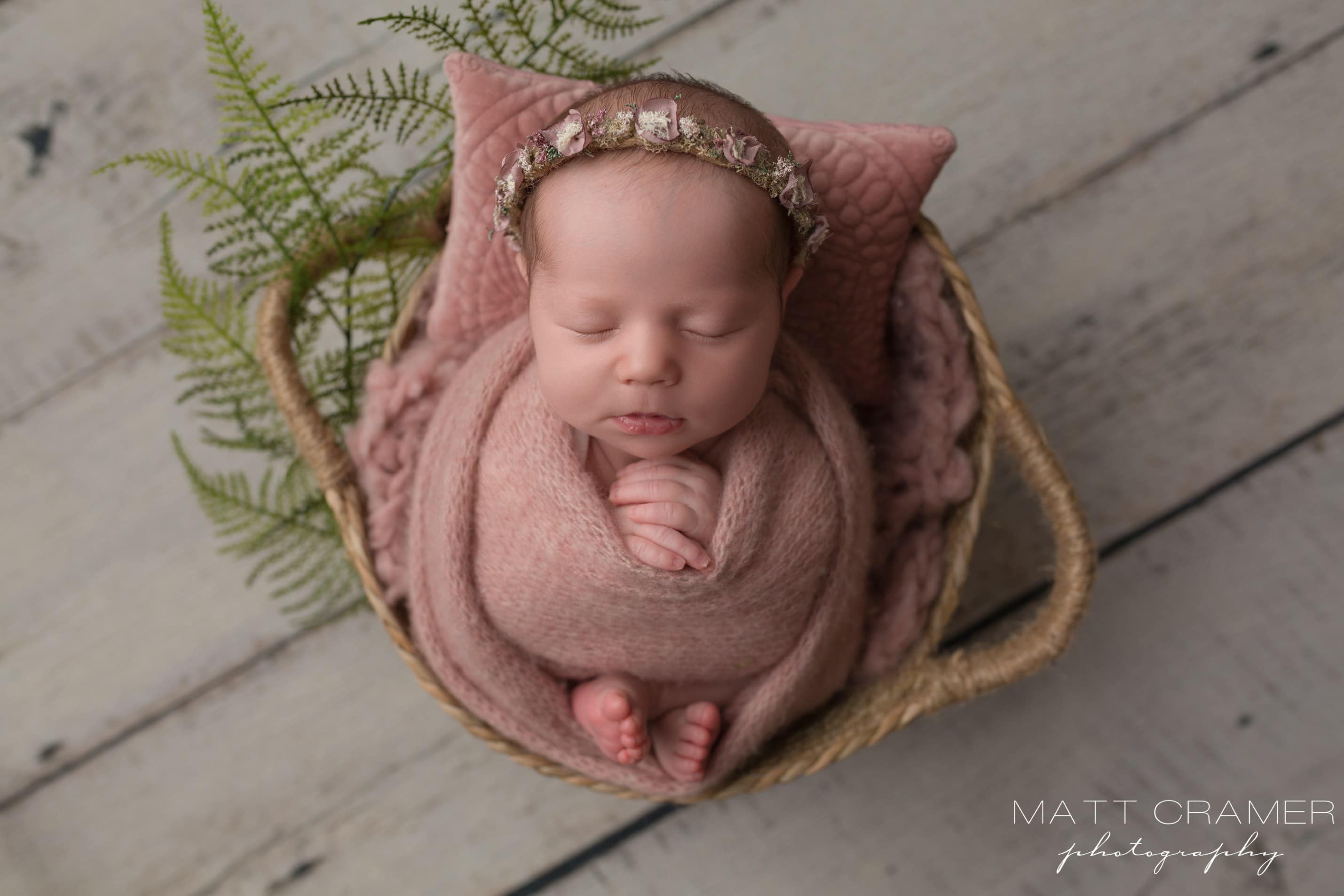 baby girl in pink swaddle 