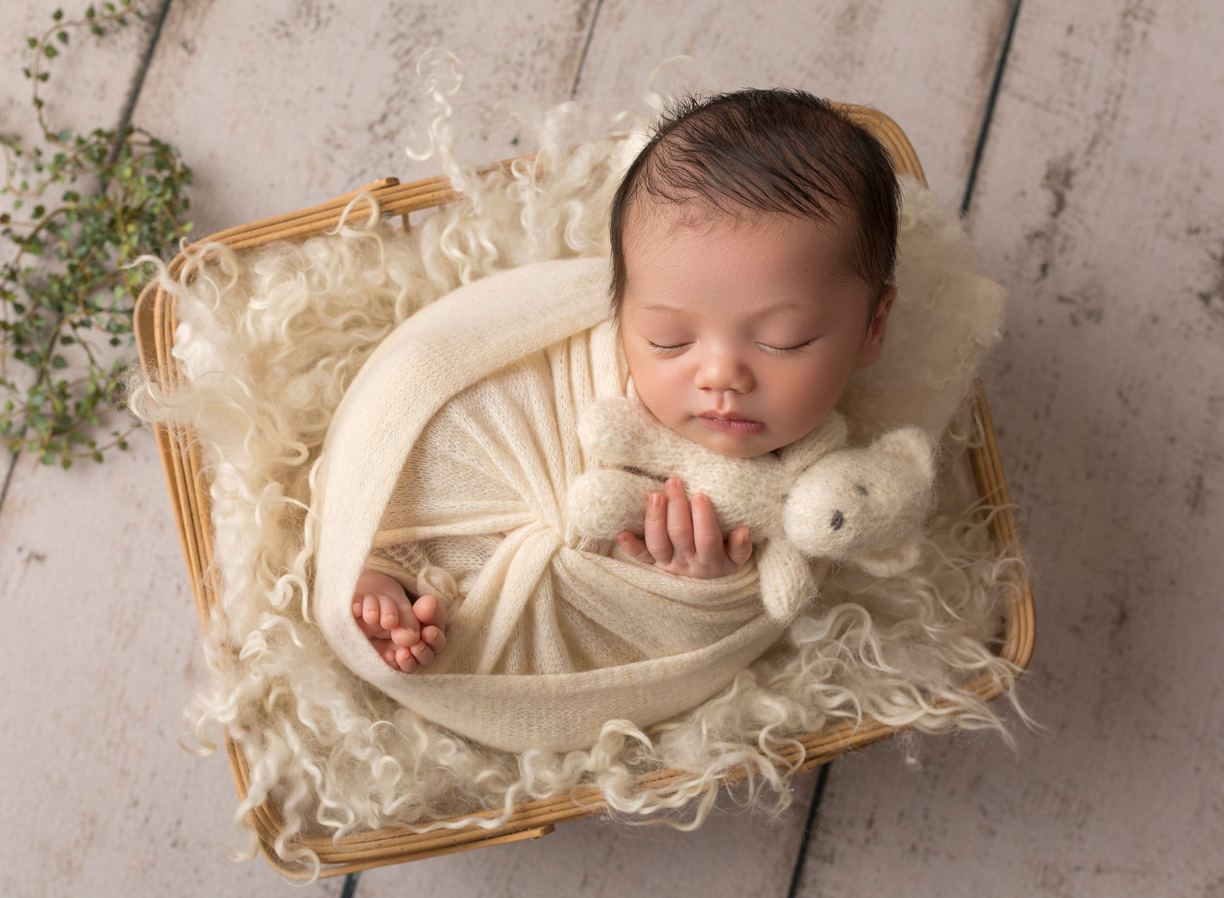 baby boy cuddling teddy bear