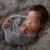 baby boy swaddled in blue wrap