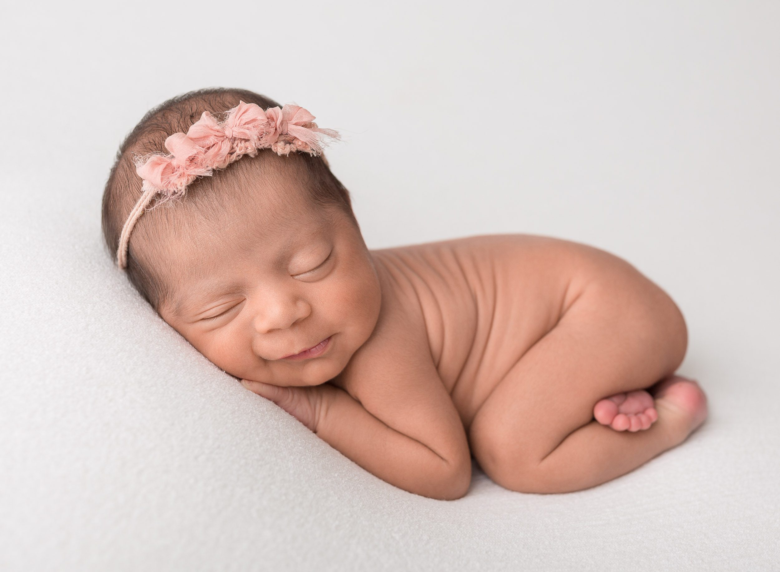 baby girl on white fabric