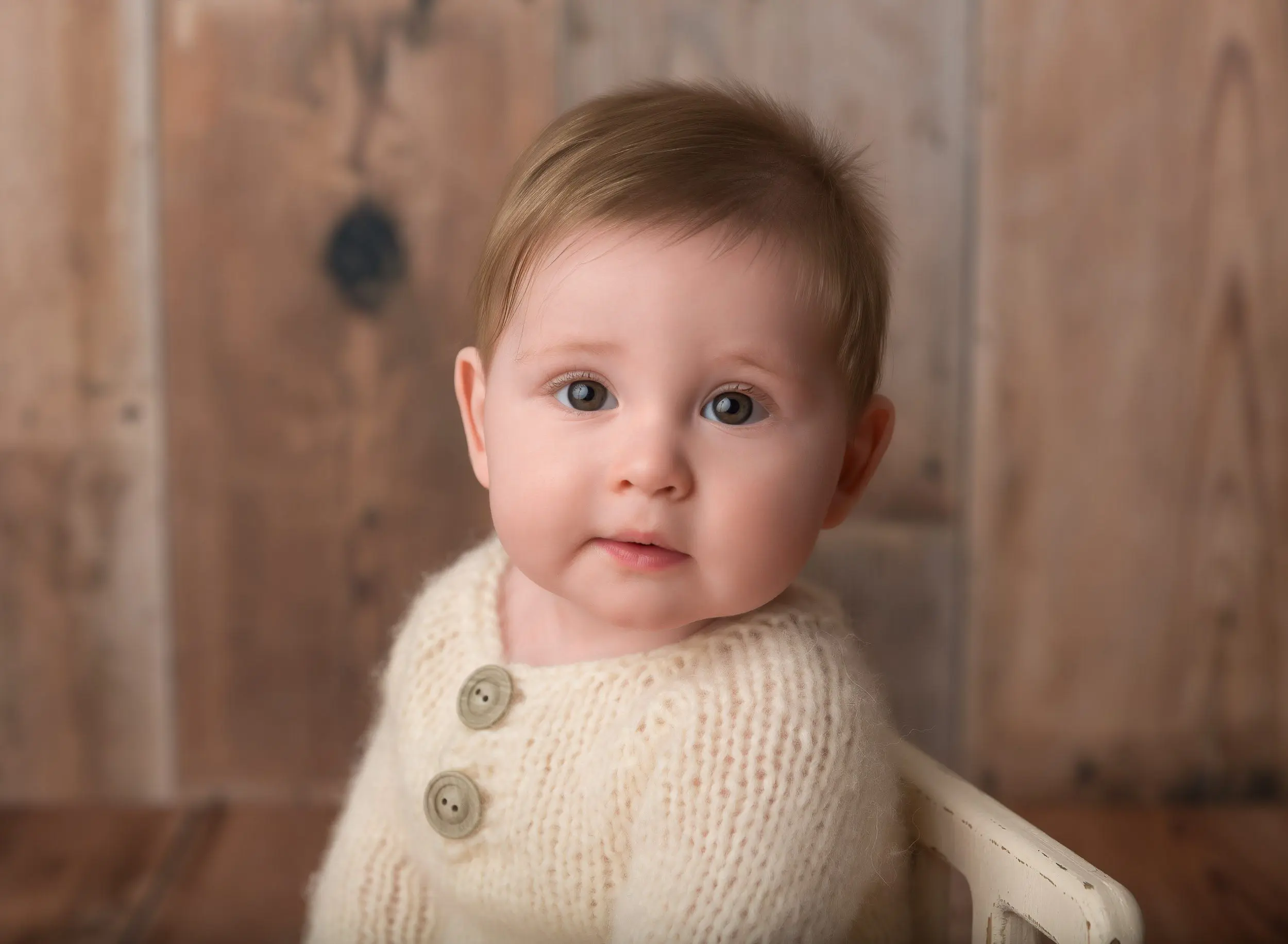 baby boy wearing cream outfit in photoshoot