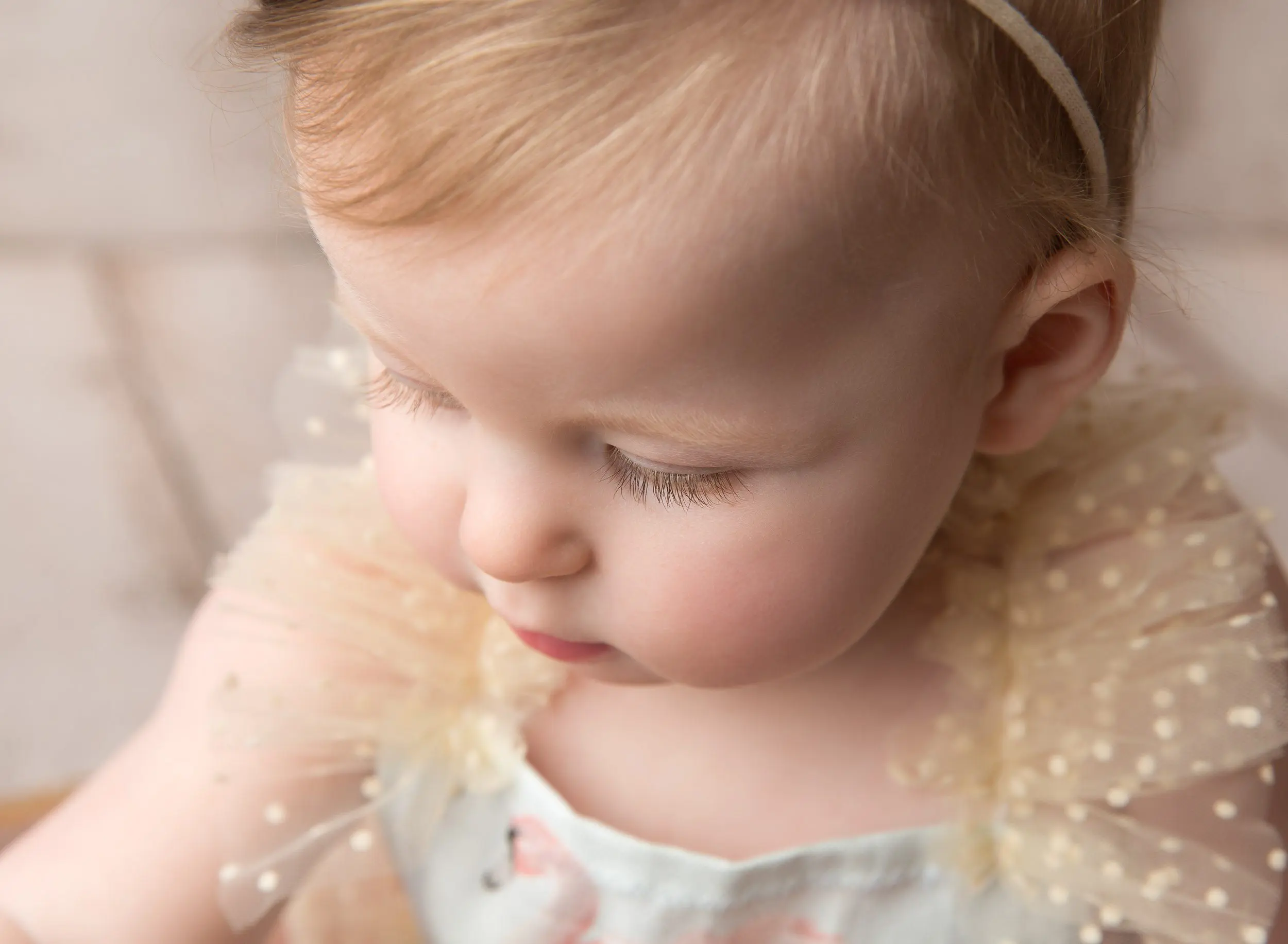 close up macro photo of baby girl face looking down