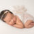 newborn photographer captures baby girl on white during a newborn photoshoot